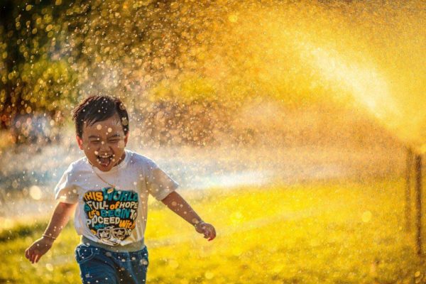 Crosswood Apartments - Rogersville Missouri - Kid Running in Sprinkler